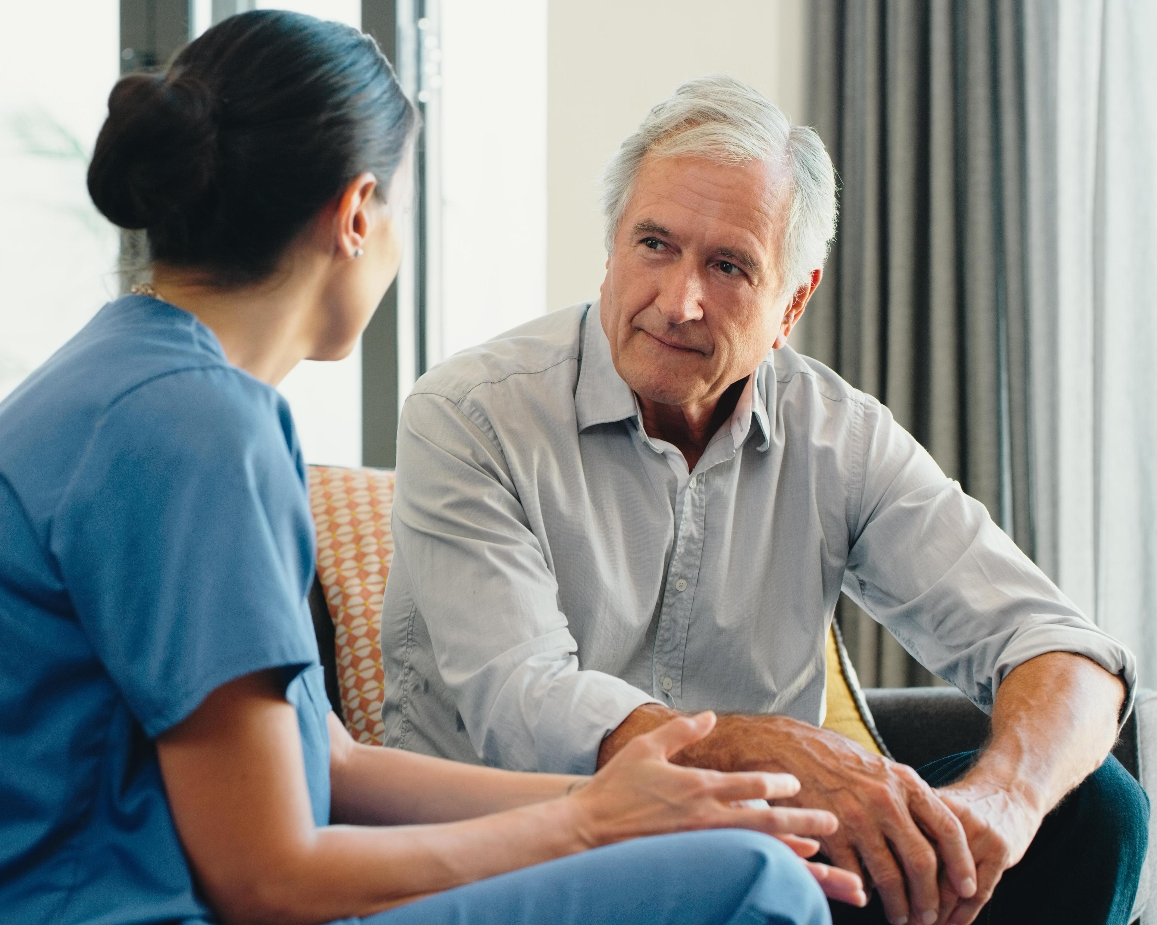 Nurse listening to male patient