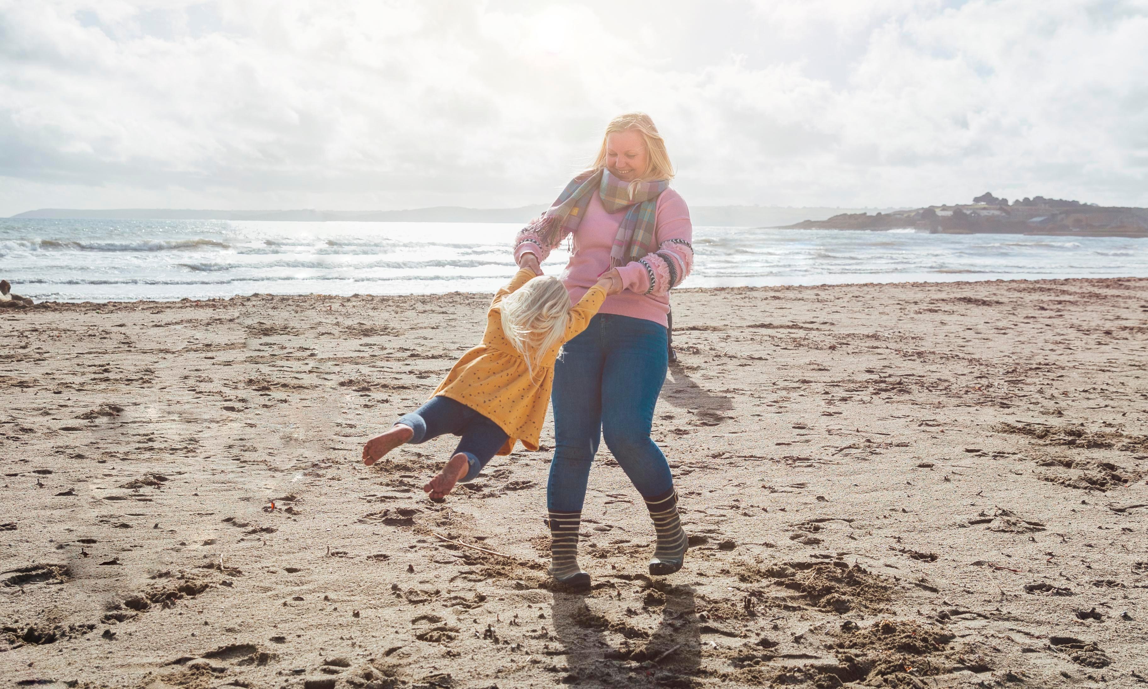 Woman and child playing on beach 1287391872.jpeg