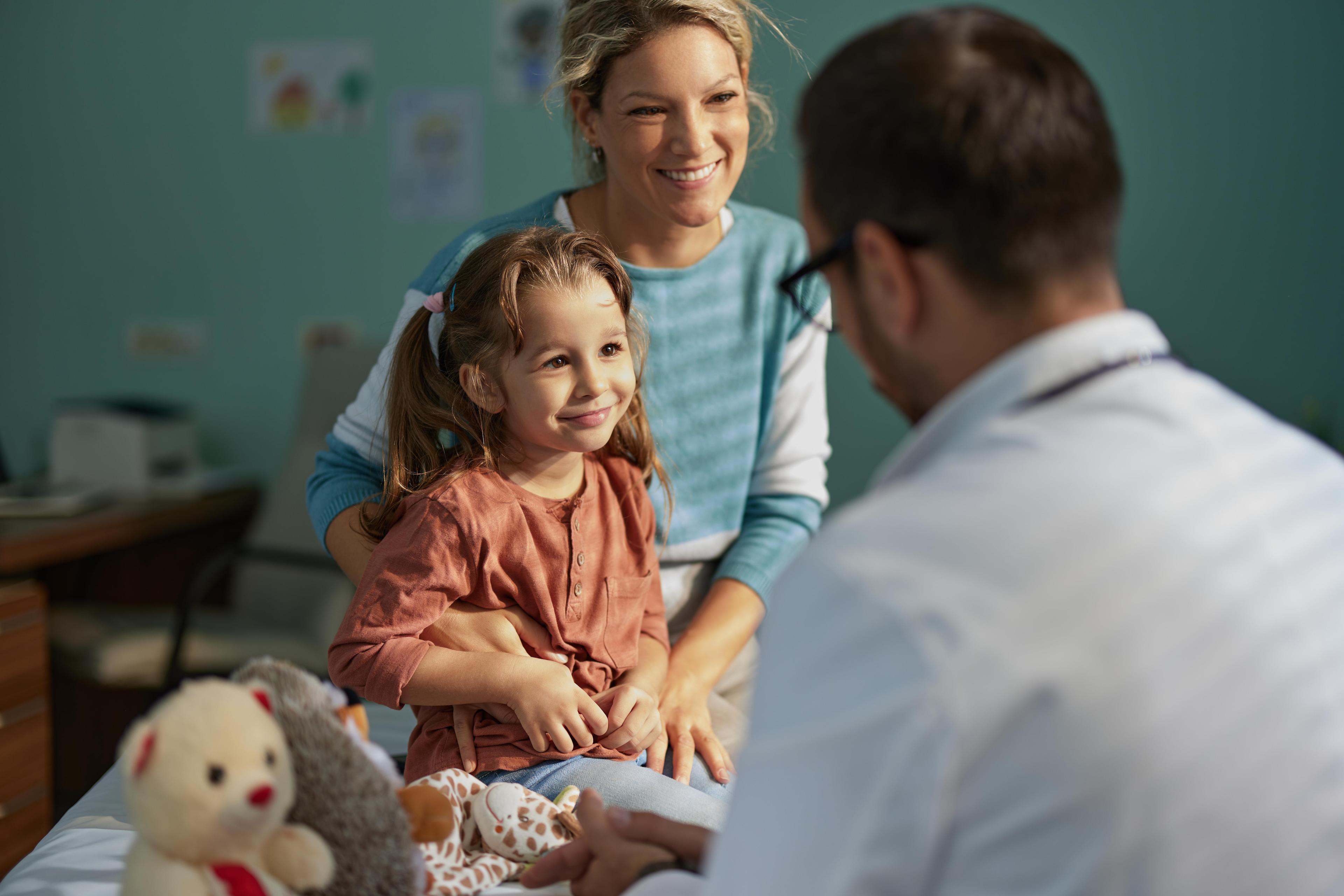 Smiling girl having an appointment with her mother at pediatricians 1535569562.jpg