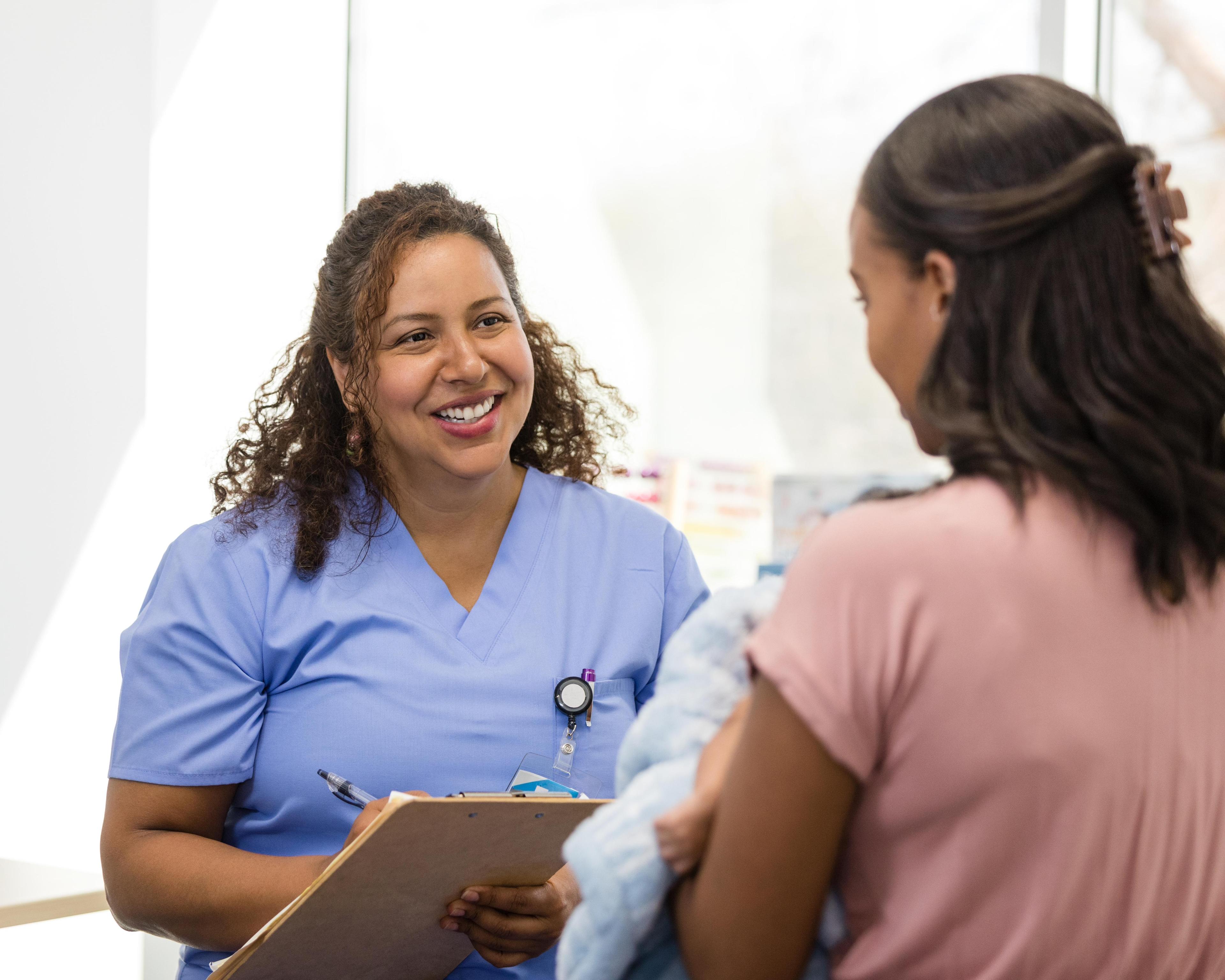 Female doctor smiles while listening to young mother 1480360672.jpg